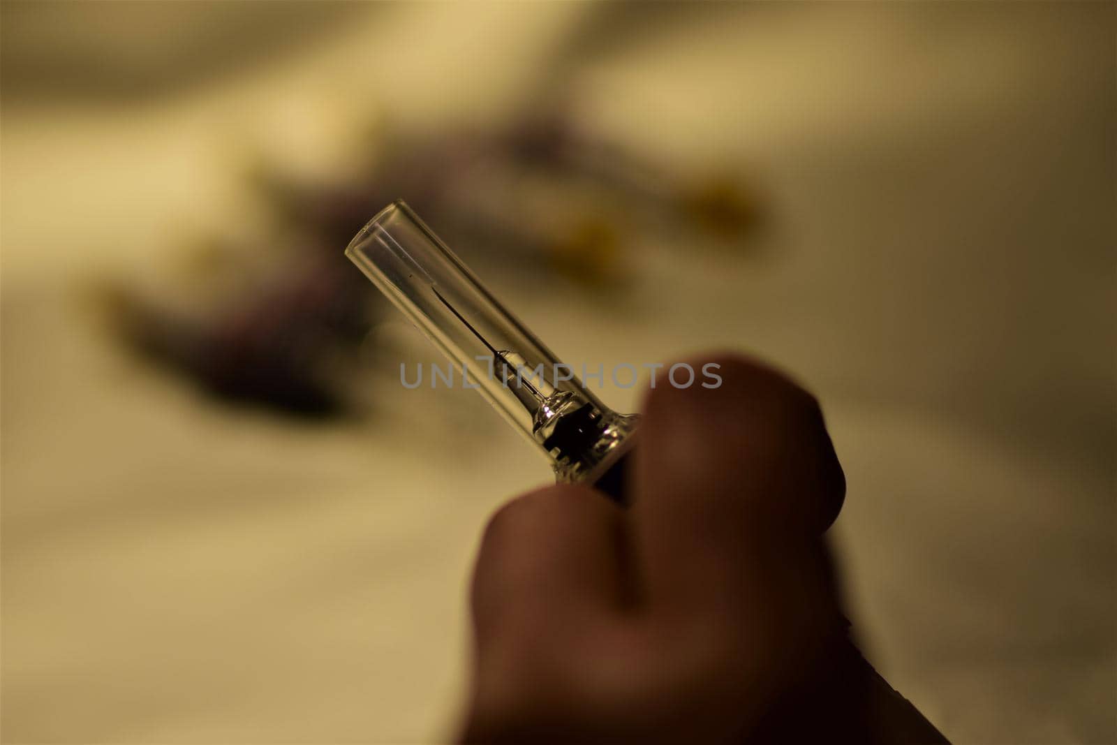 close-up of a hand holding an injection