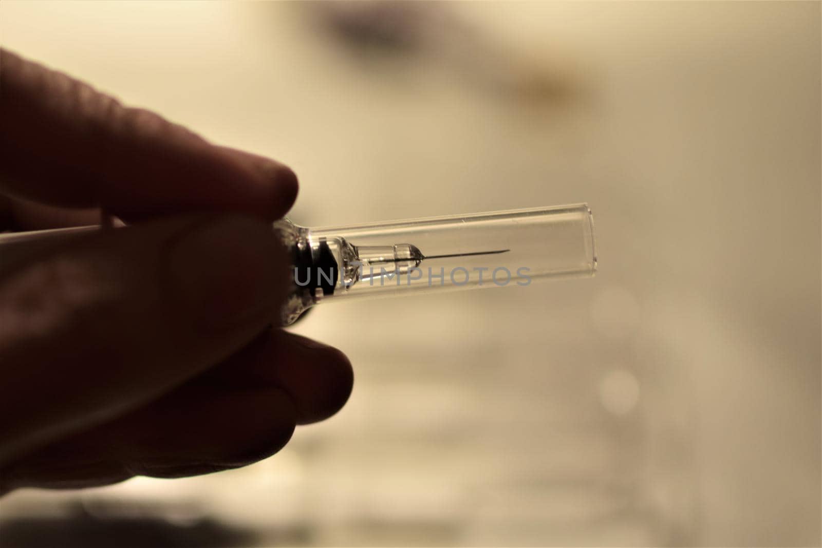 close-up of a hand holding an injection