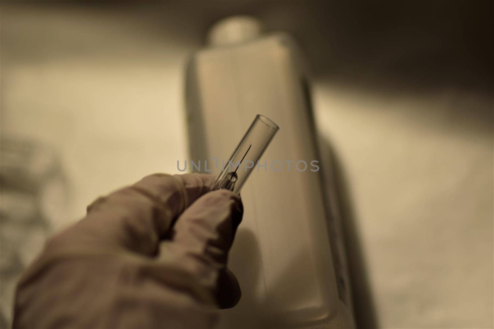close-up of a hand holding an injection