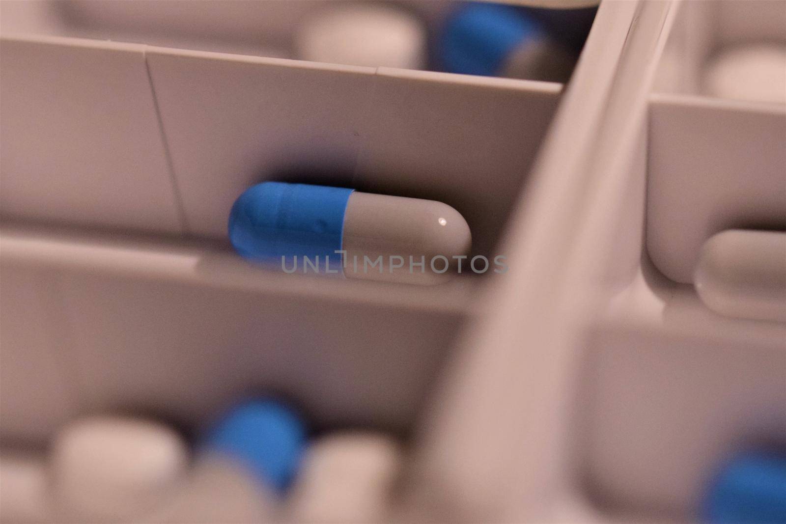Close-up of different pills prepared in tablets boxes