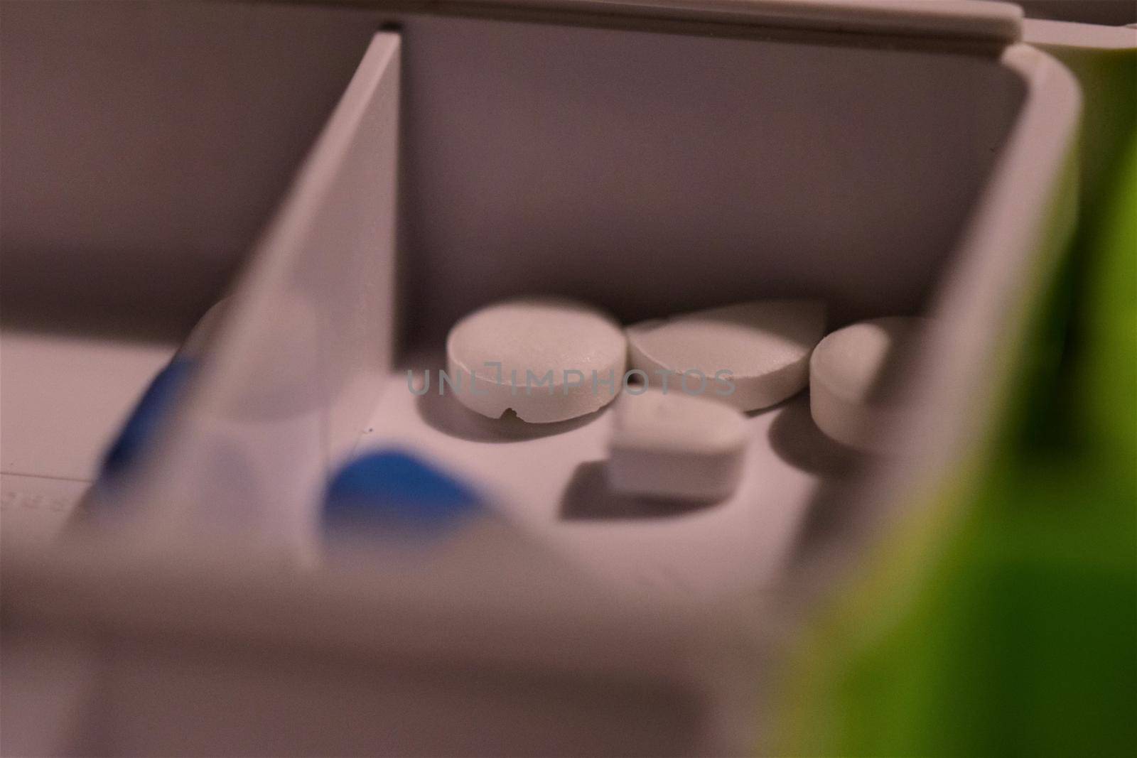 Close-up of different pills prepared in tablets boxes
