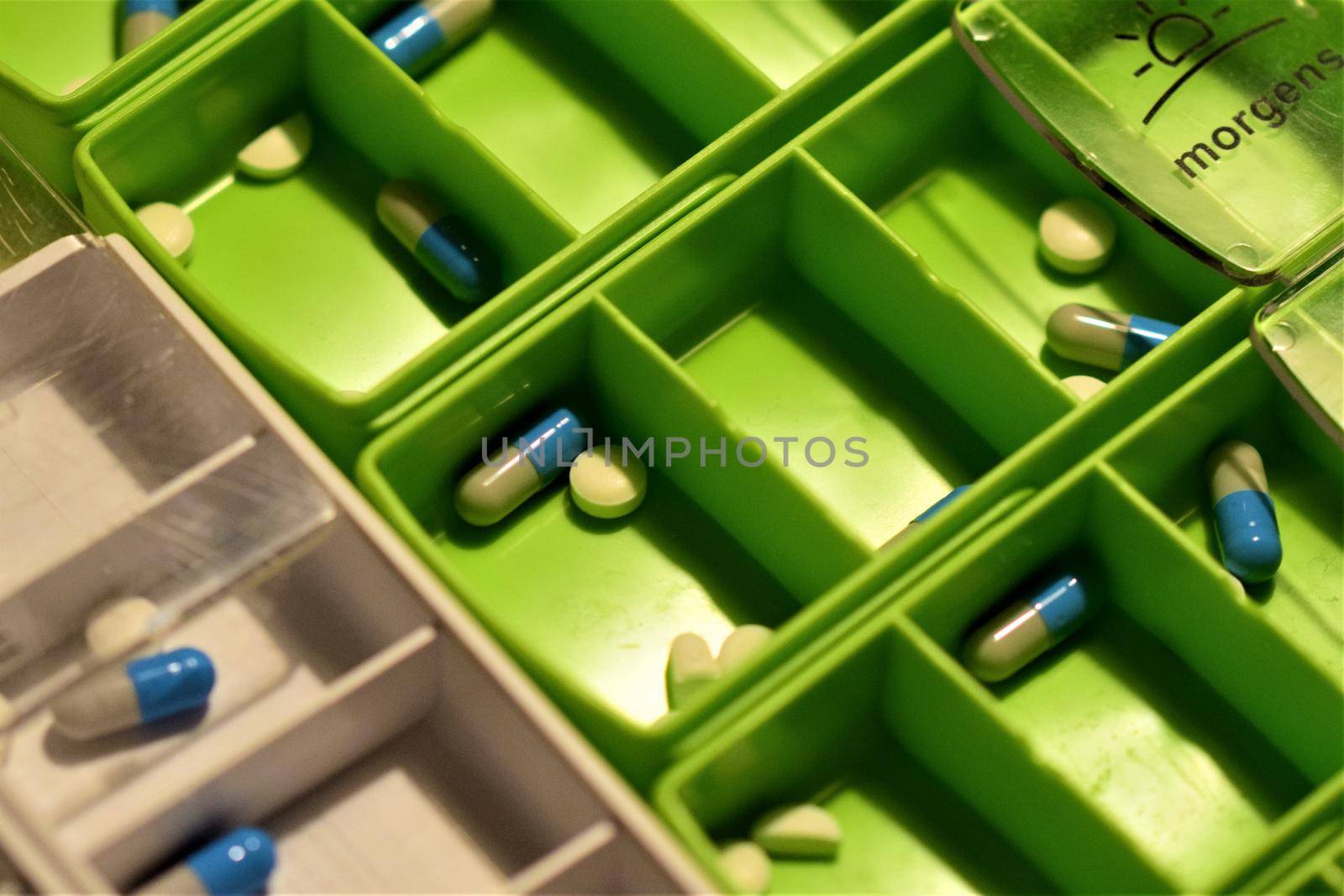 Close-up of different pills prepared in tablets boxes