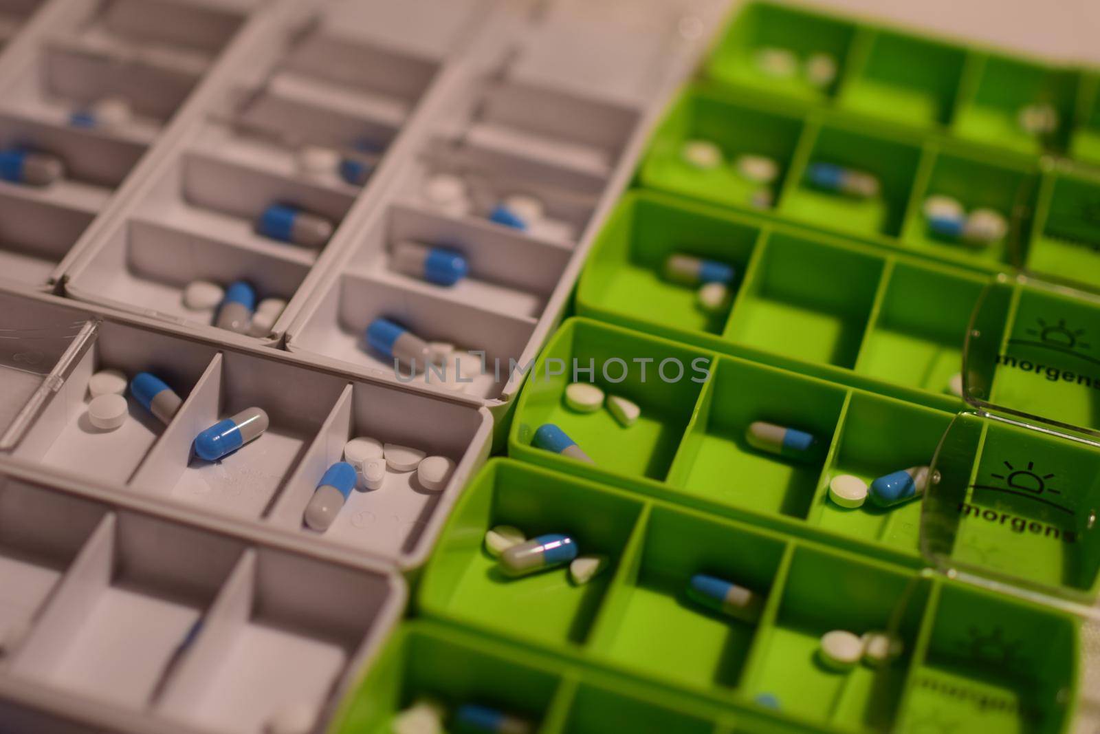 Close-up of different pills prepared in tablets boxes