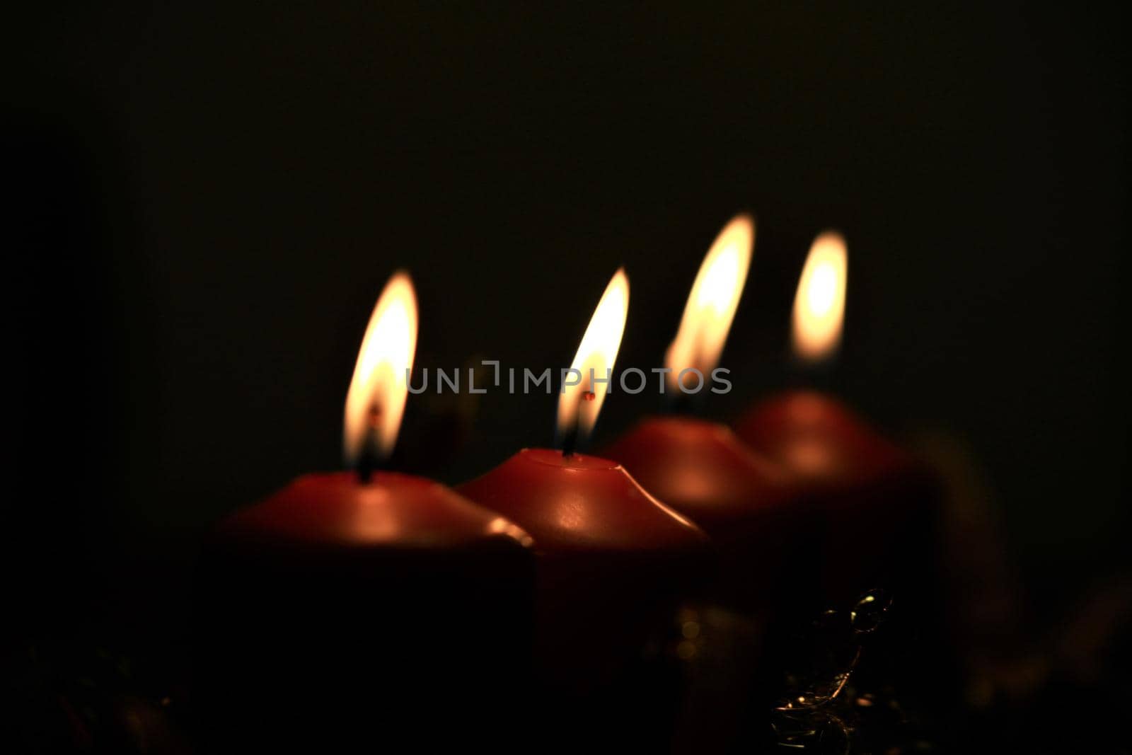 close-up of an Advent arrangement with 4 burning candles