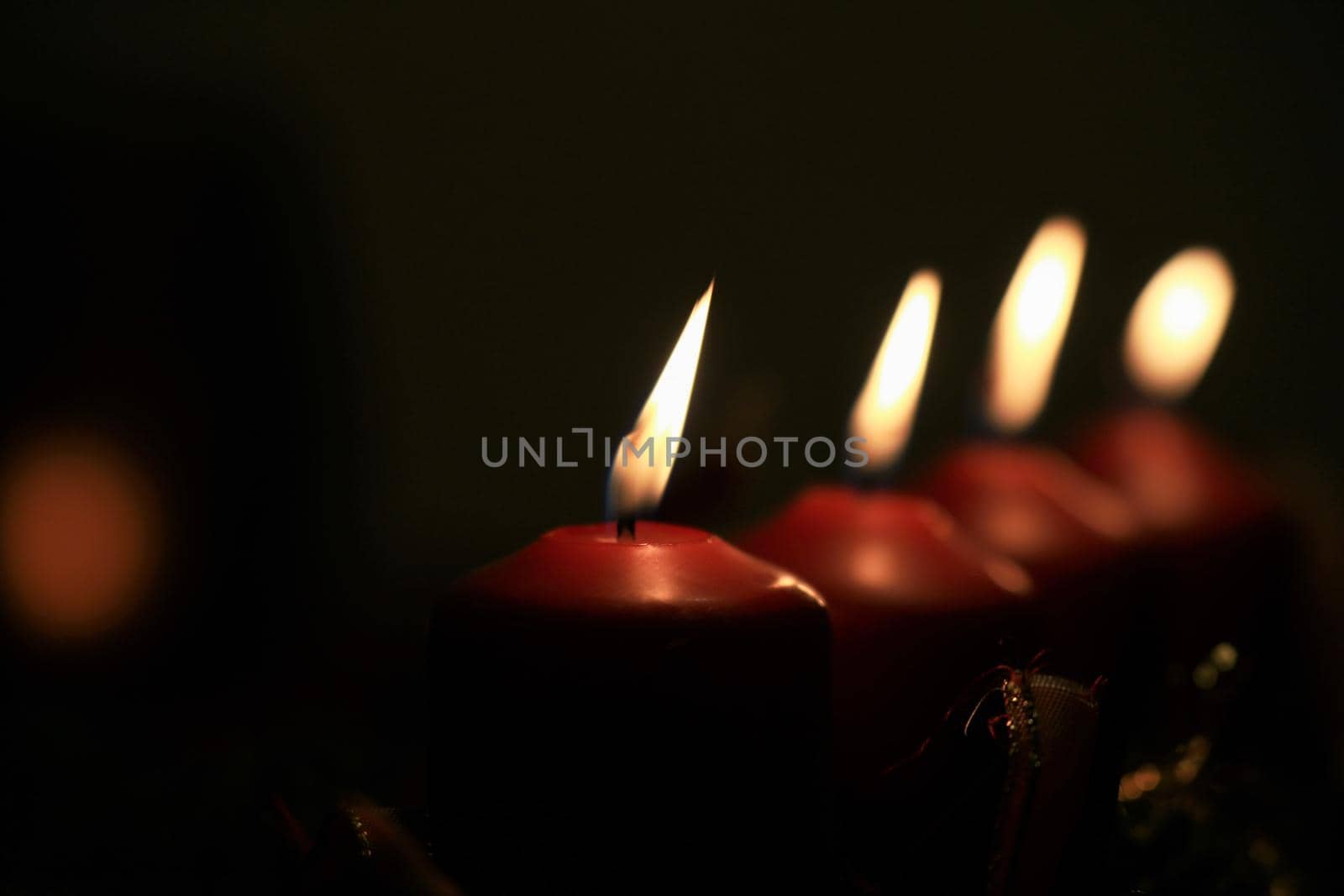 close-up of an Advent arrangement with 4 burning candles