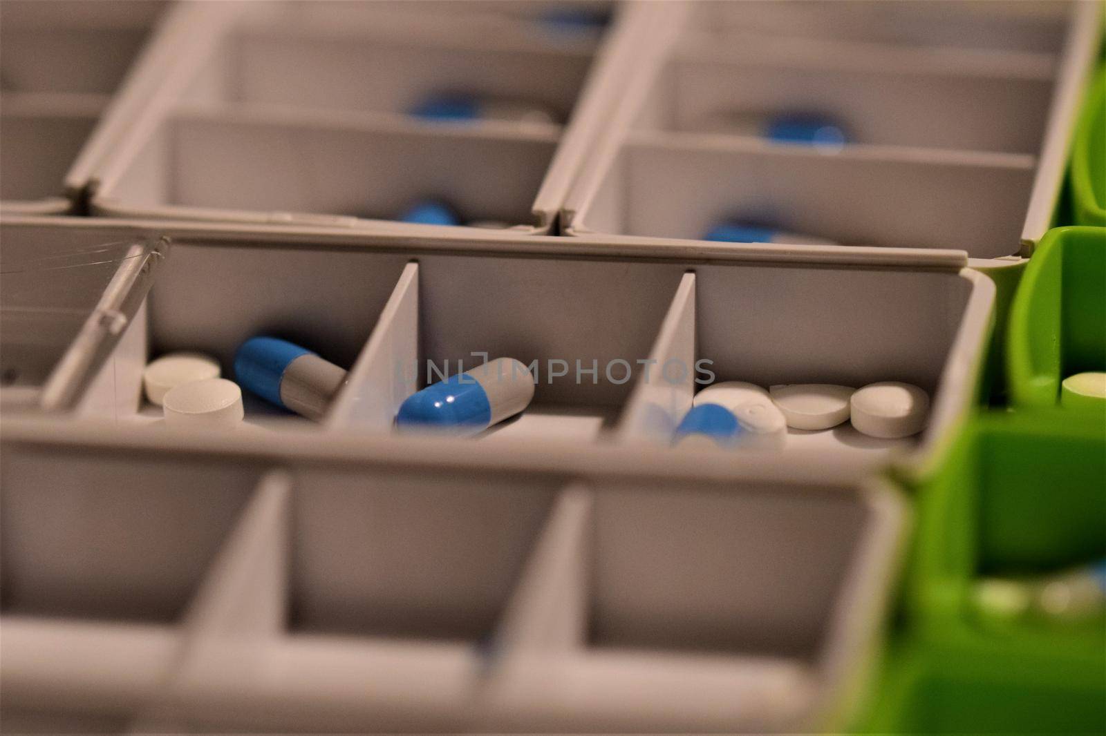 Close-up of different pills prepared in tablets boxes