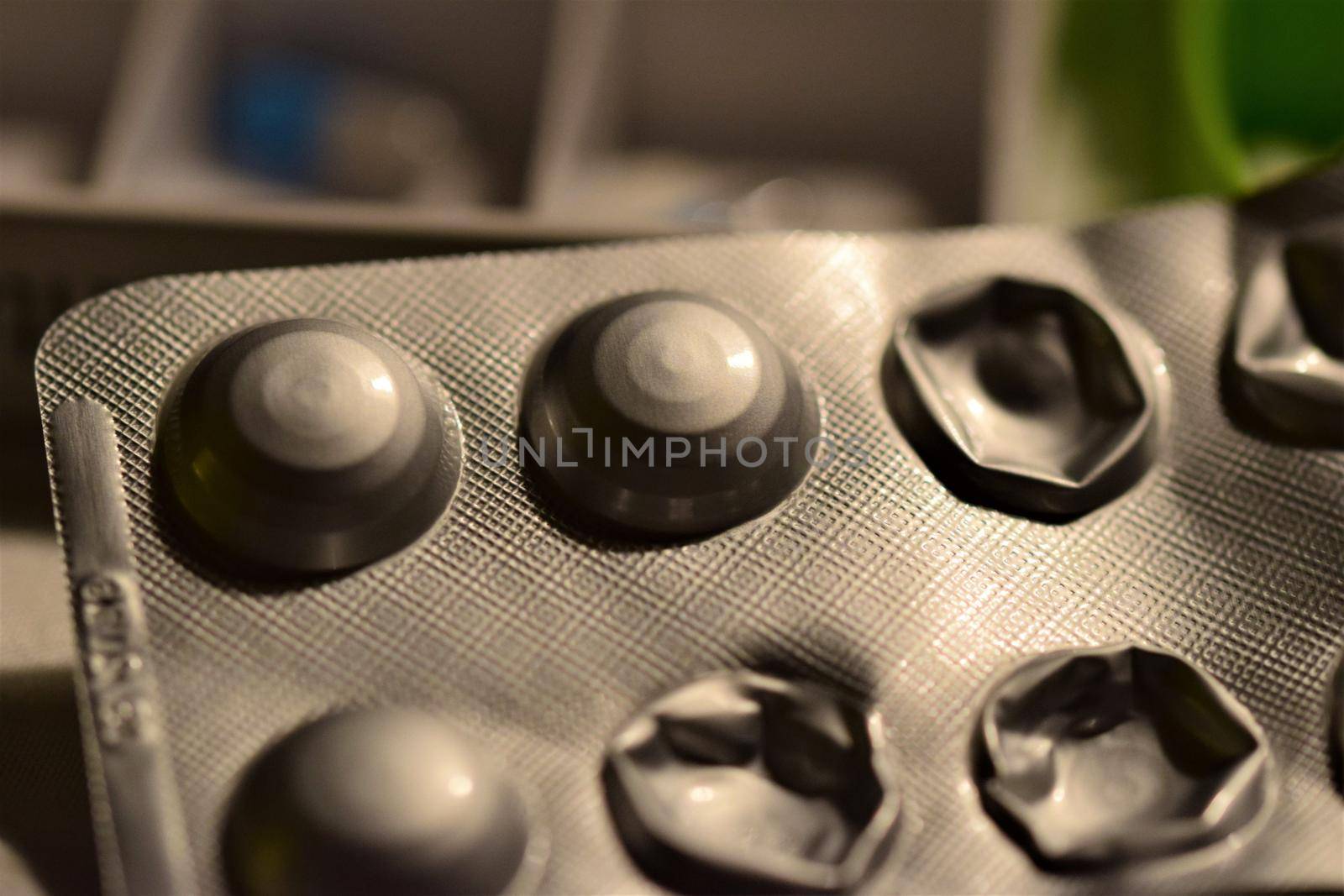 Opened tablets blister as a close up against a blurry background