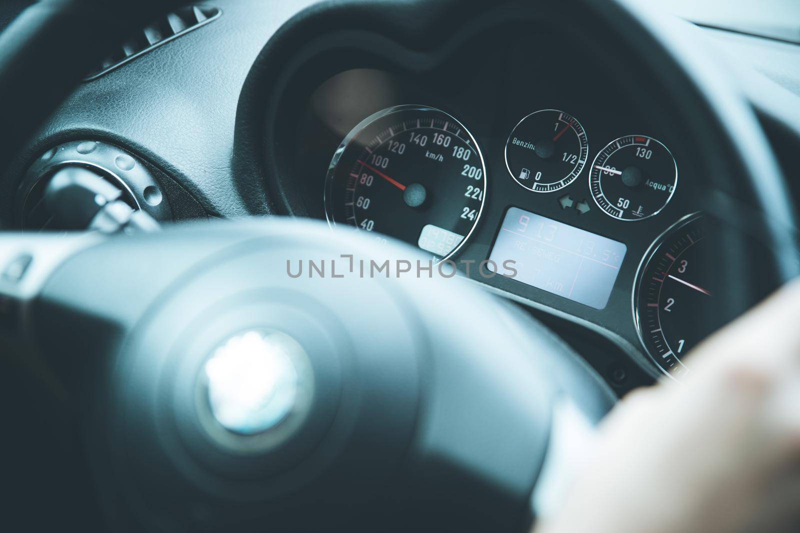Female hands on a sports car steering wheel, car interior
