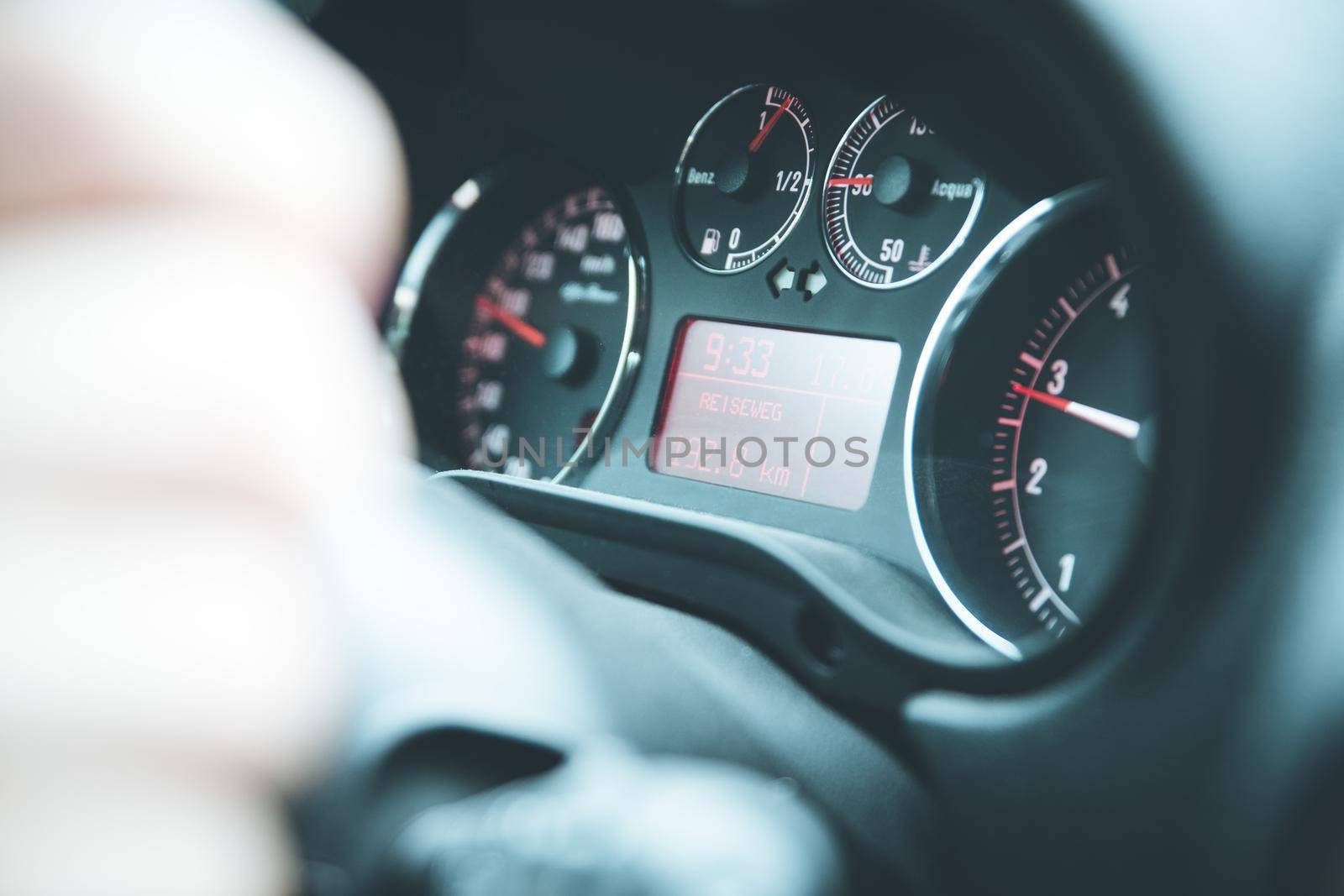 Female hands on a sports car steering wheel, car interior