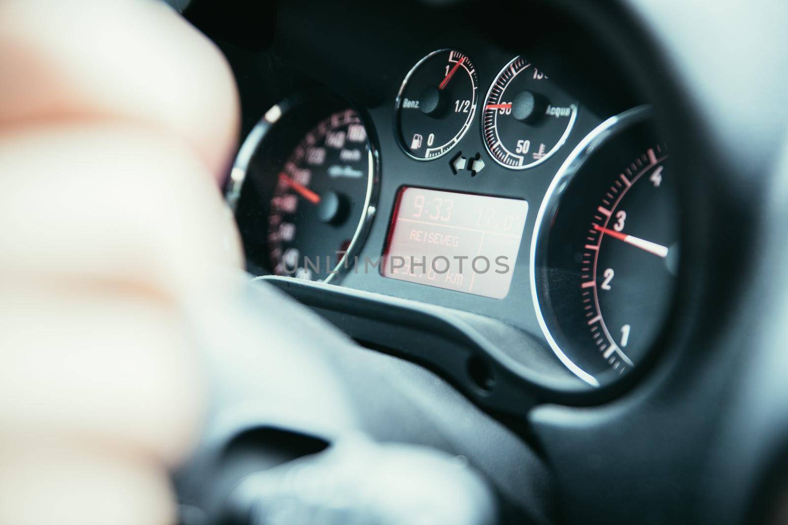Female hands on a sports car steering wheel, car interior