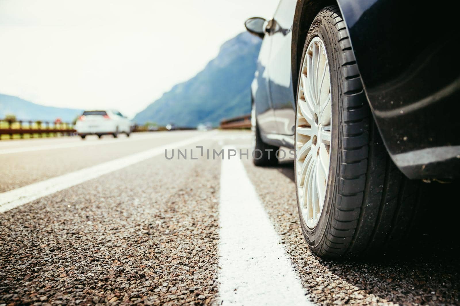 Close up of a car standing on a breakdown lane, summer vacation