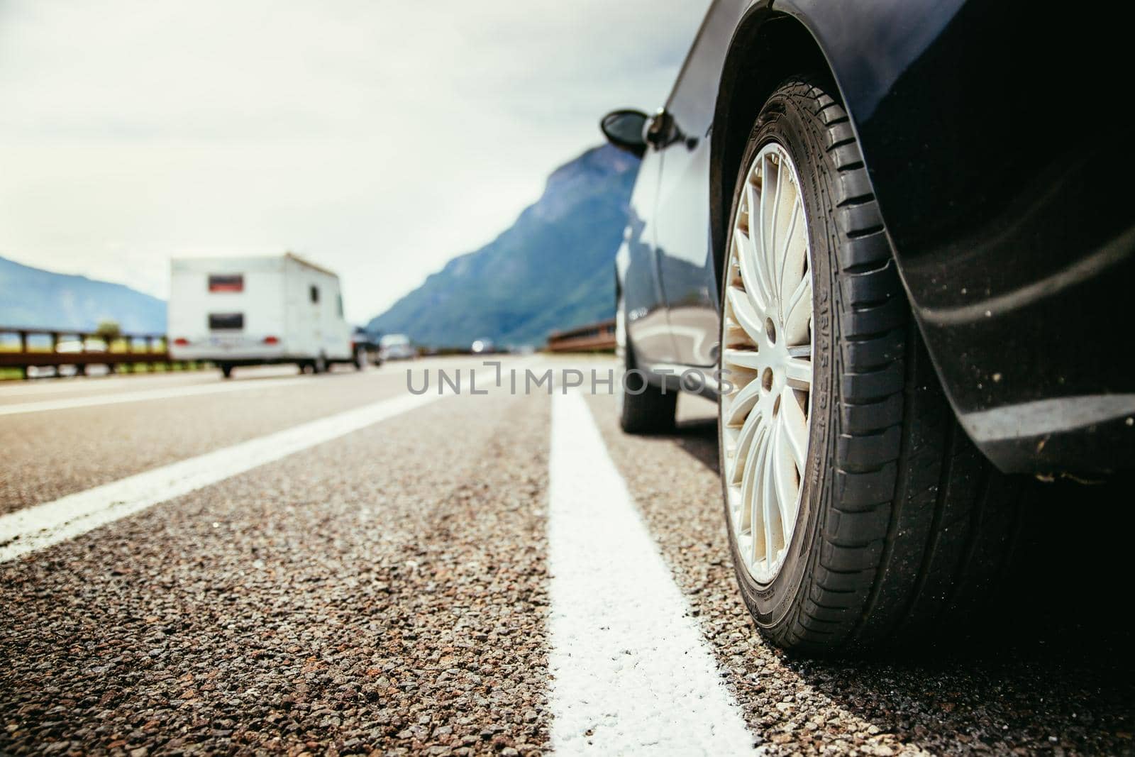 Close up of a car standing on a breakdown lane, summer vacation