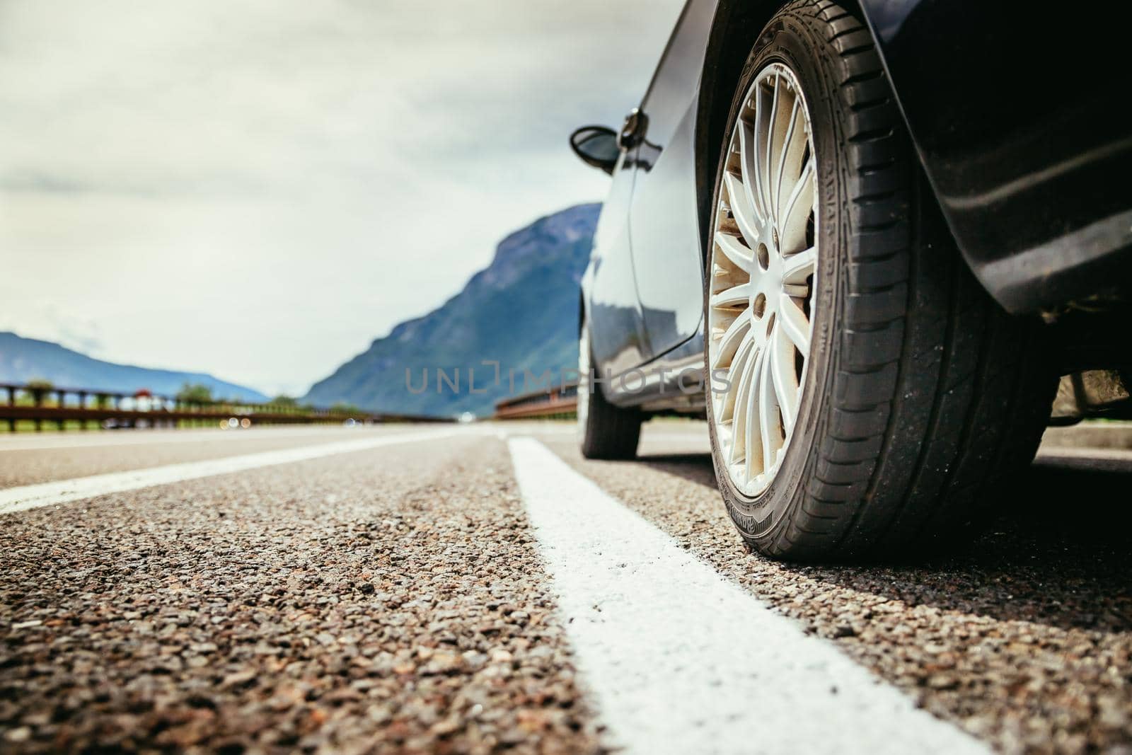 Close up of a car standing on a breakdown lane, summer vacation