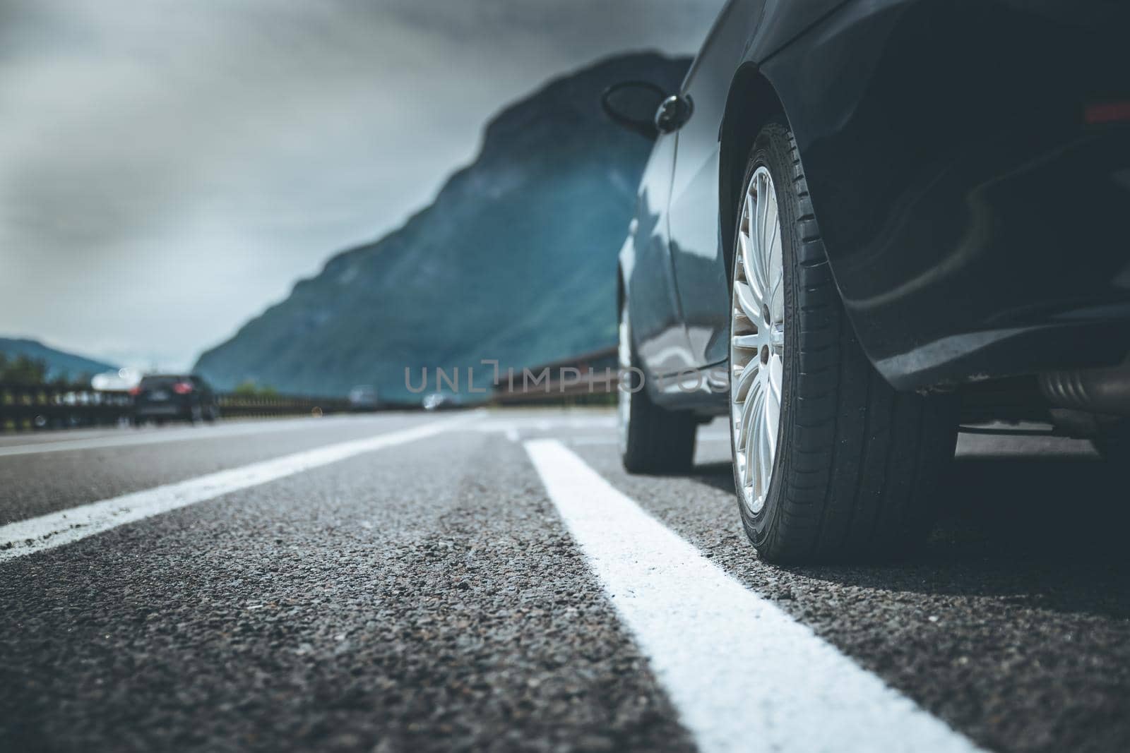 Close up of a car standing on a breakdown lane, summer vacation