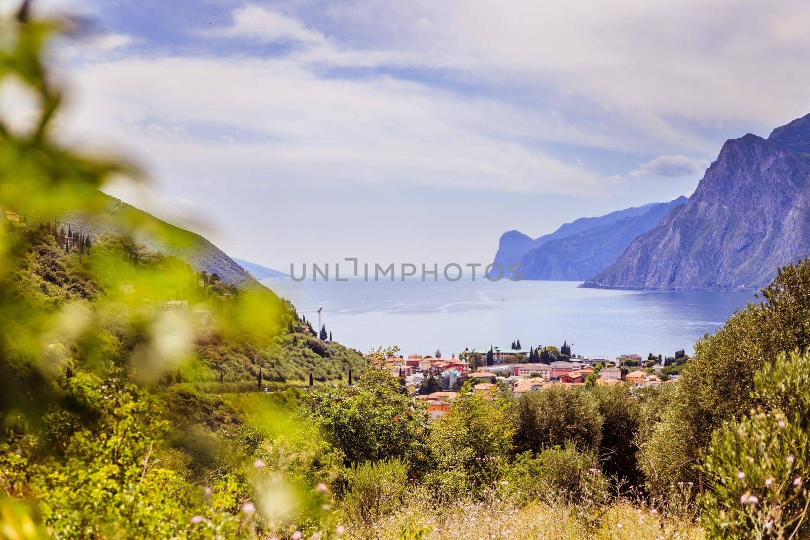 Idyllic landscape Italy, Lago di Garda: Mountains, a small village and a lake by Daxenbichler