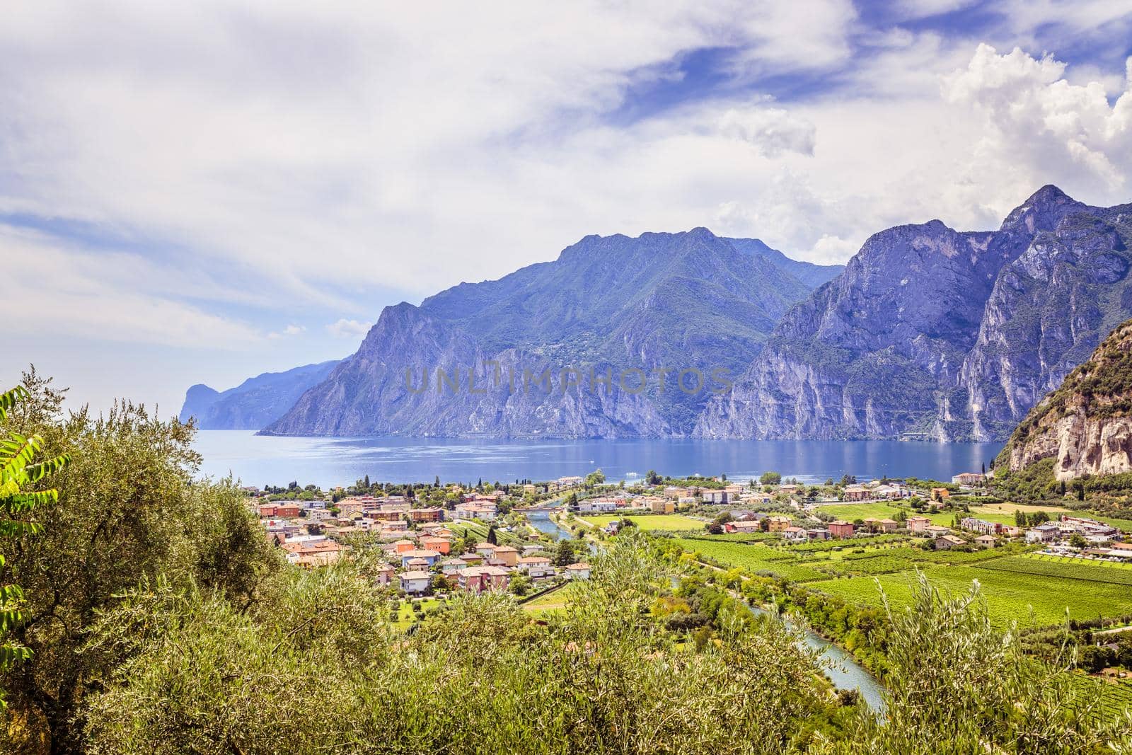 Idyllic landscape Italy, Lago di Garda: Mountains, a small village and a lake by Daxenbichler