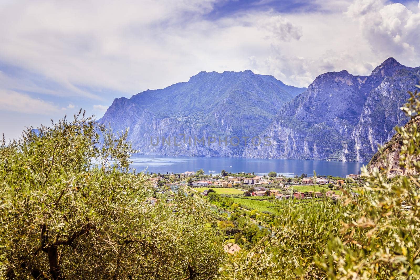 Idyllic landscape Italy, Lago di Garda: Mountains, a small village and a lake by Daxenbichler