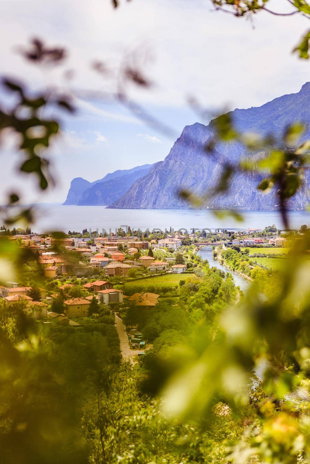 Idyllic landscape Italy, Lago di Garda: Mountains, a small village and a lake by Daxenbichler