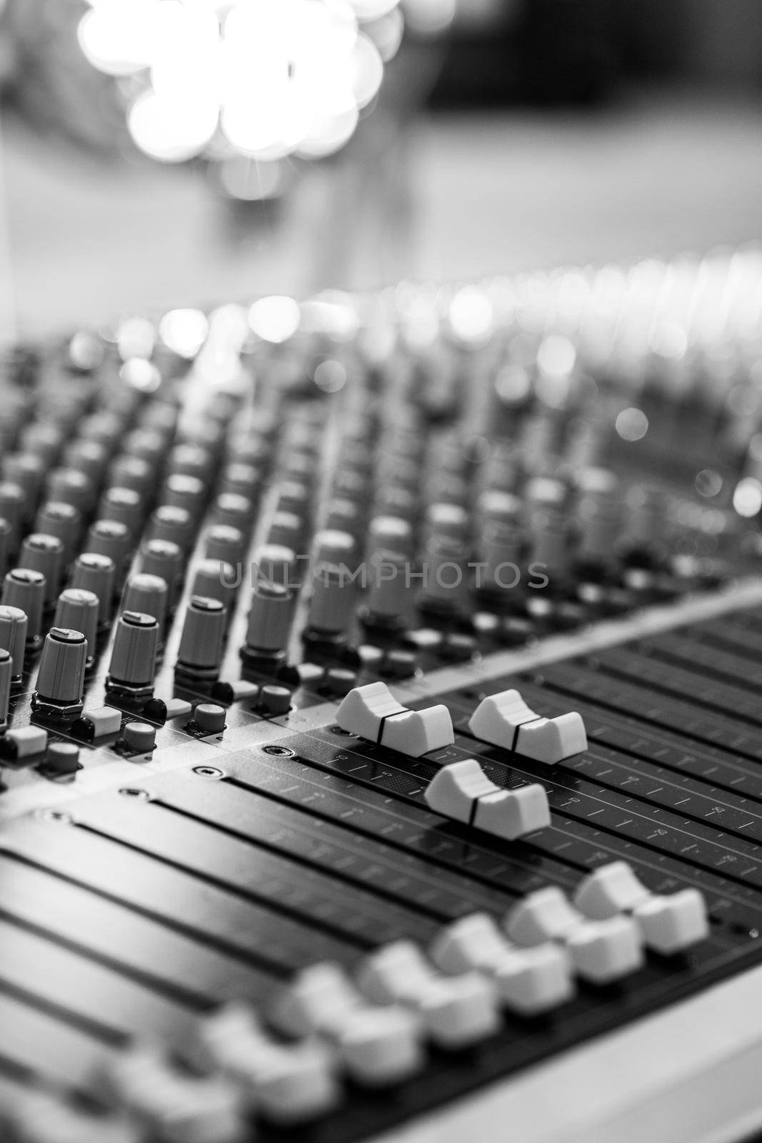 Professional music production in a sound recording studio, mixer desk