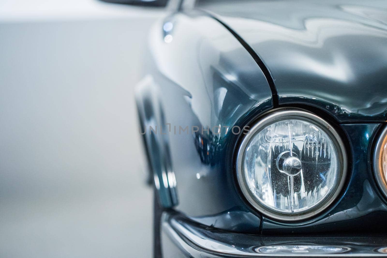 Lights of a reflecting green vintage car