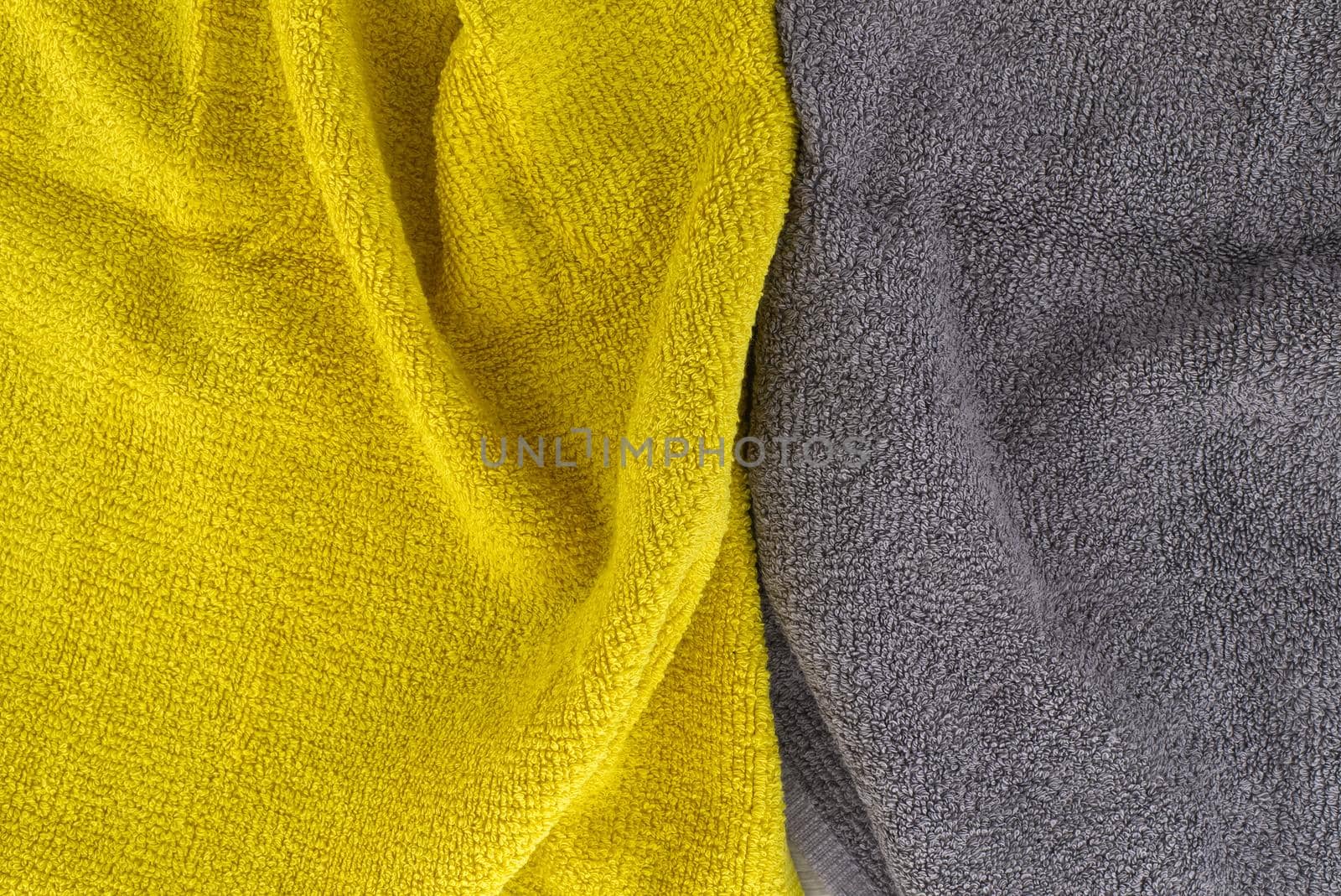 Two tone grey and yellow frote textile background with copy space viewed as a flat lay. Main color trend of the year