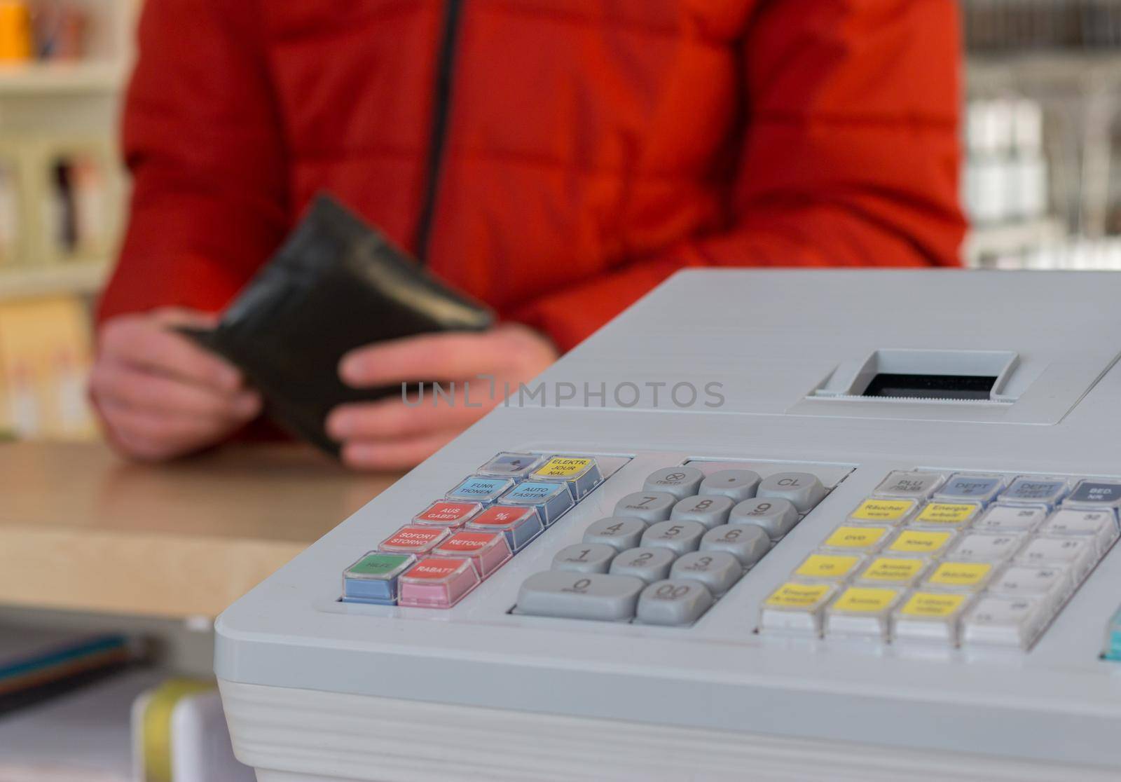 Cash register in a store: Customer is paying. by Daxenbichler