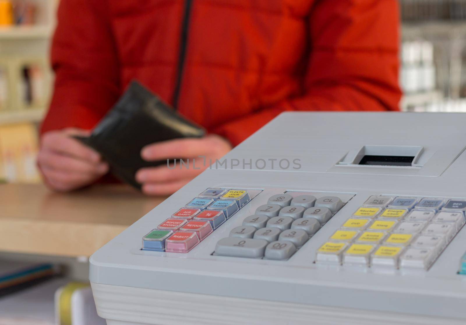 Cash register in a shop: Customer is paying purchase