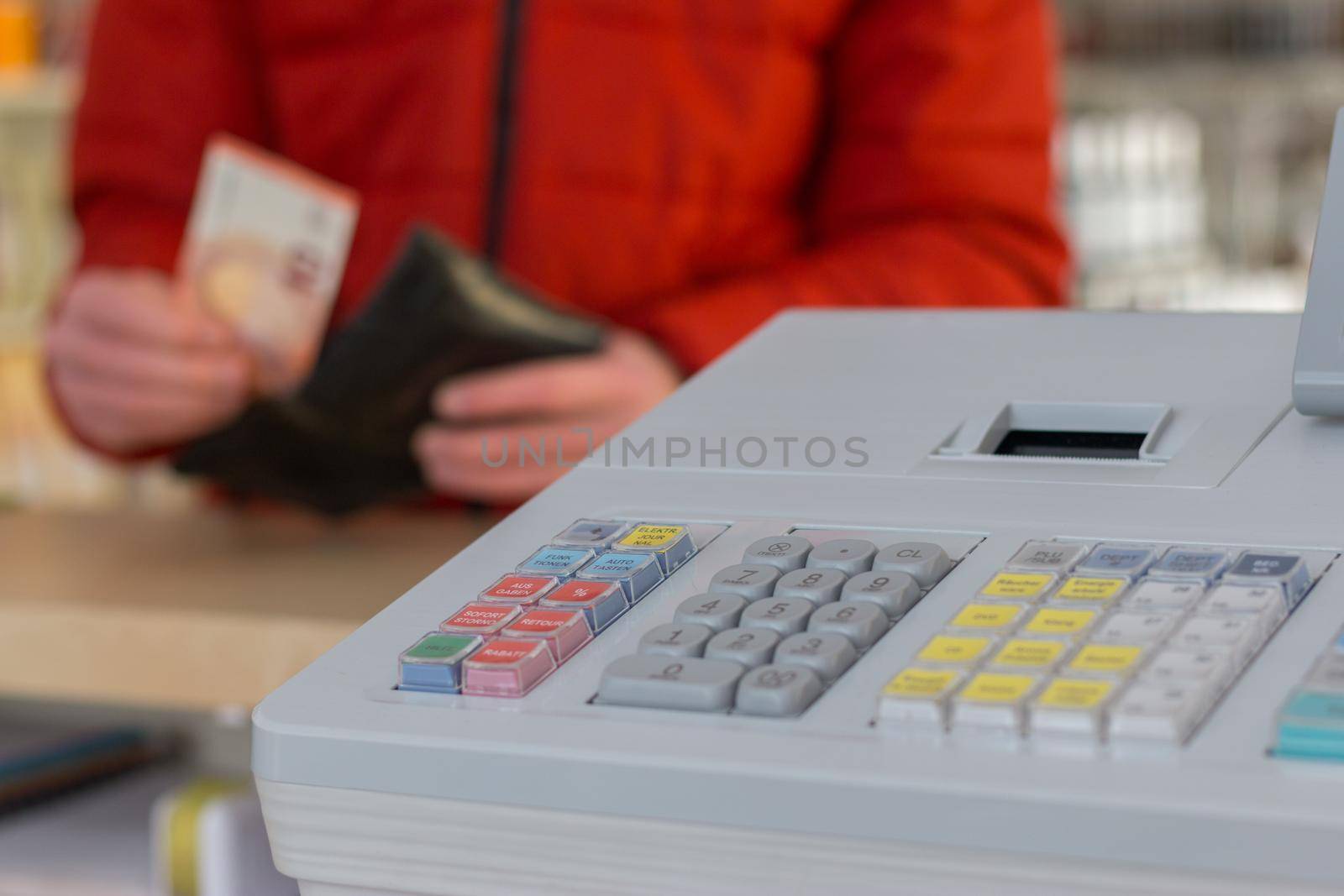 Cash register in a shop: Customer is paying purchase