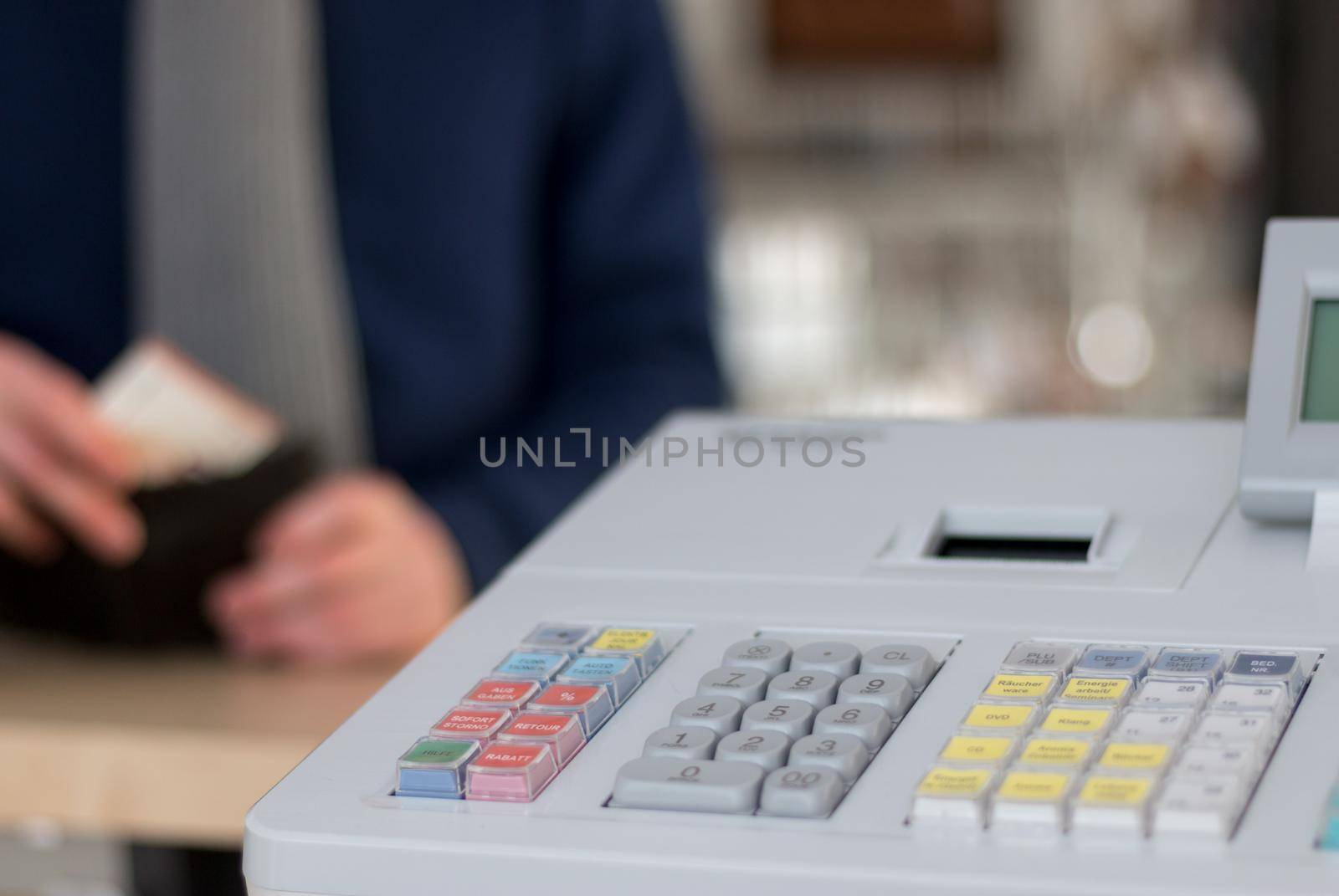 Cash register in a shop: Customer is paying purchase