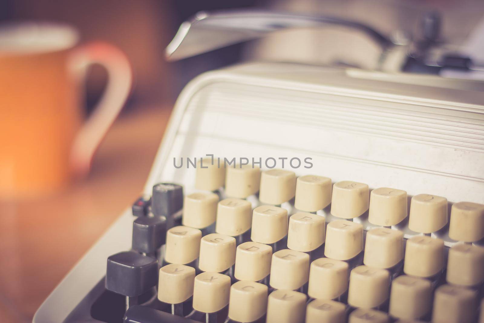 Vintage typewriter on a wooden desk, cutout