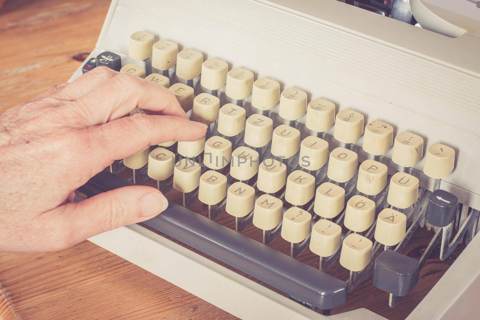 Vintage typewriter on a wooden desk, cutout