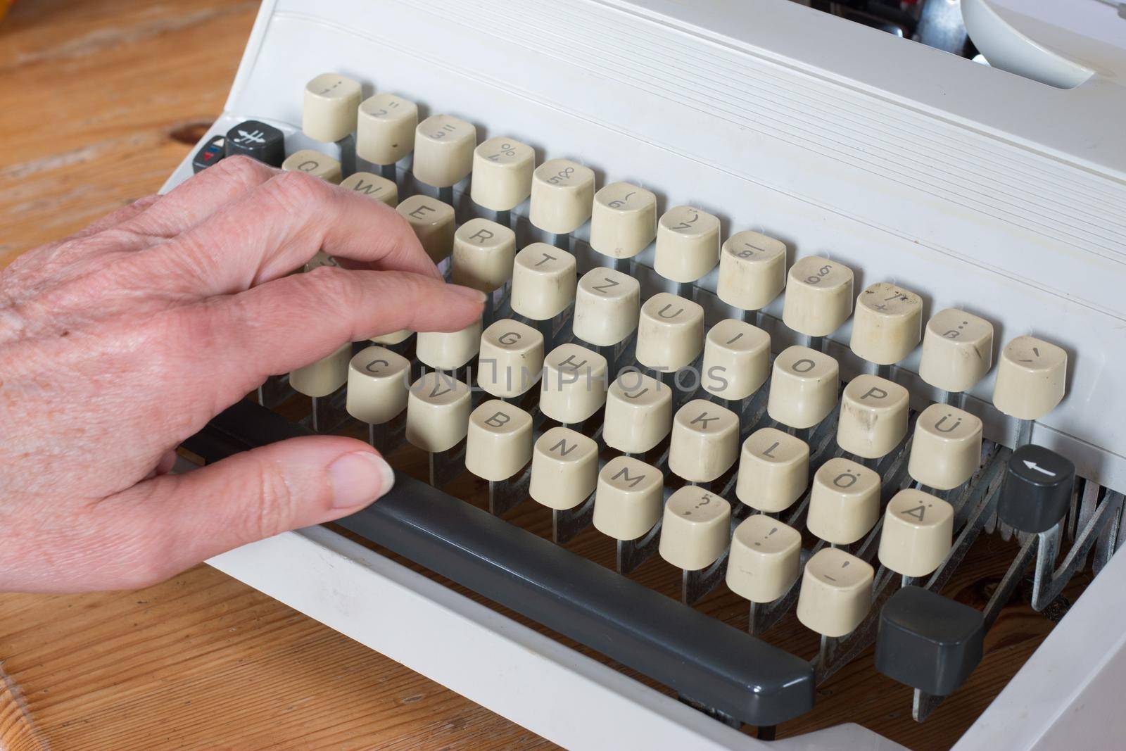 Vintage typewriter on a wooden desk, cutout