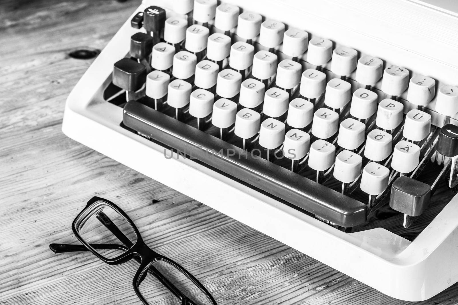 Vintage typewriter on a wooden desk, cutout
