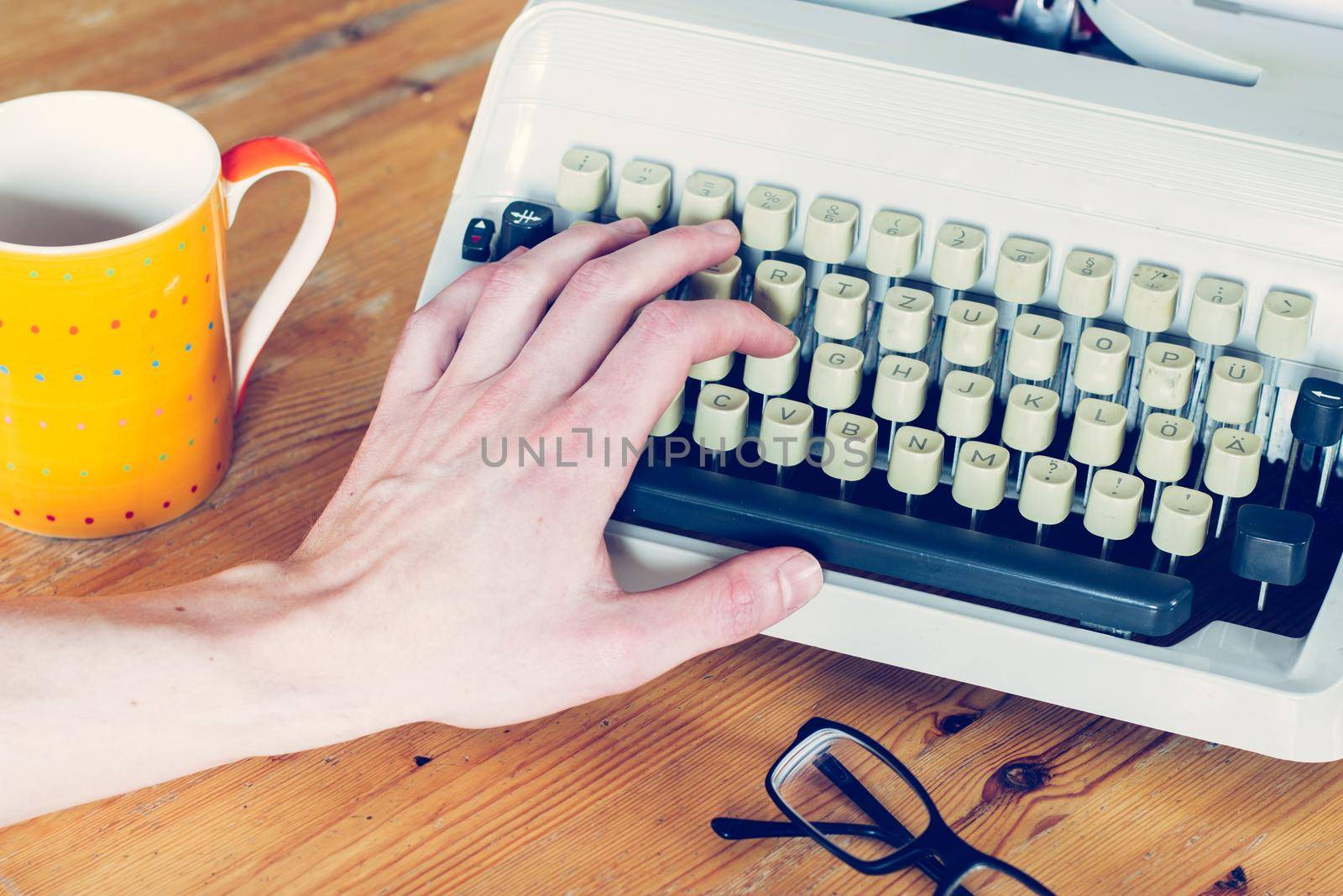 Vintage typewriter on a wooden desk, cutout