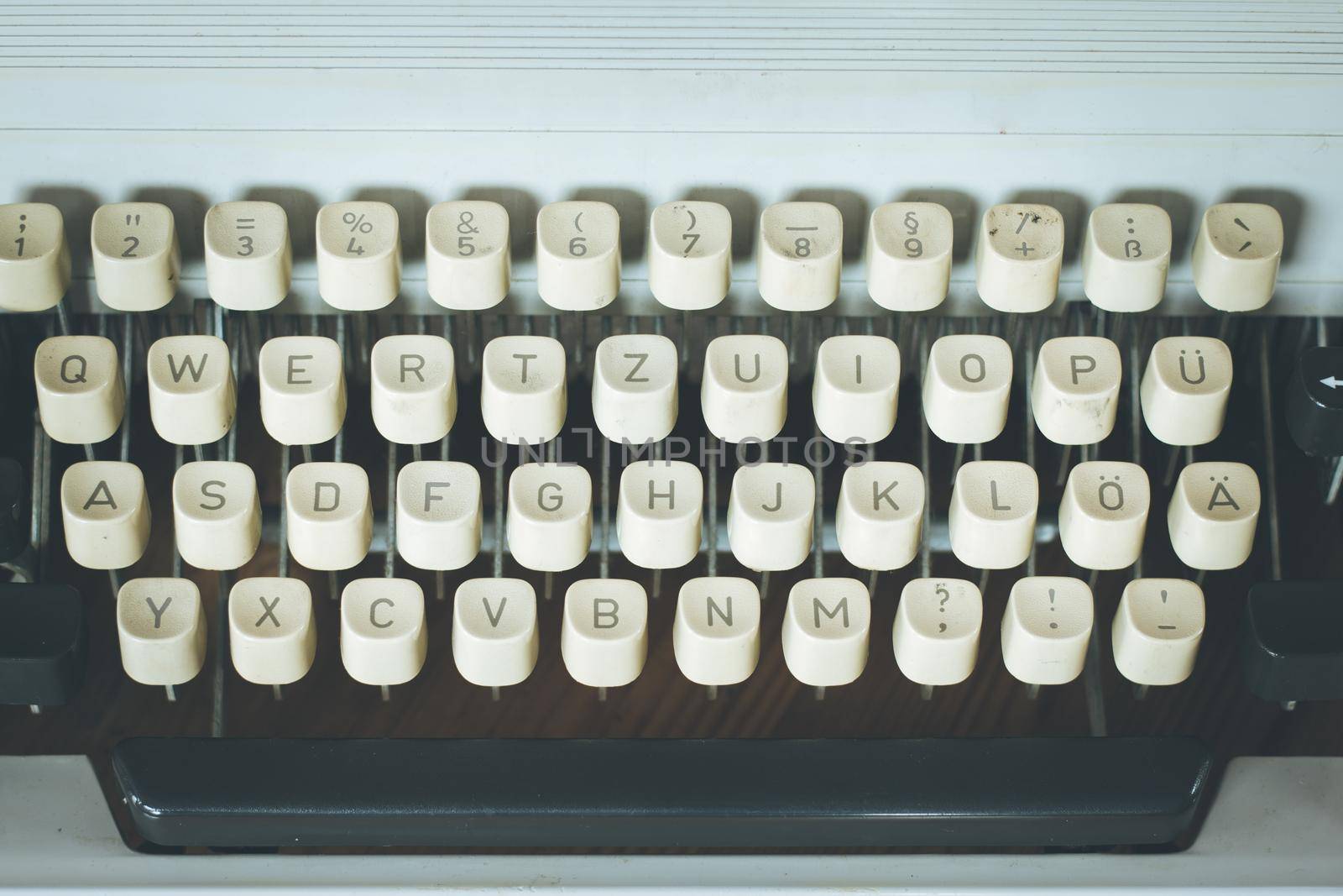 Vintage typewriter on a wooden desk, cutout