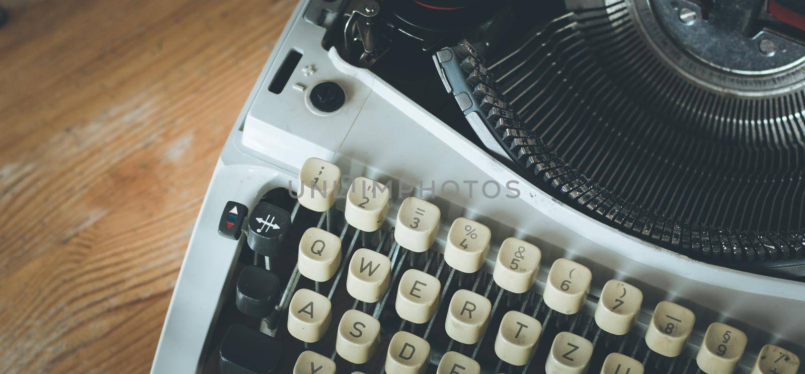 Vintage typewriter on a wooden desk, cutout