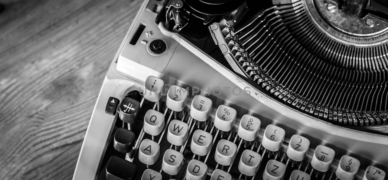 Vintage typewriter on a wooden desk, cutout