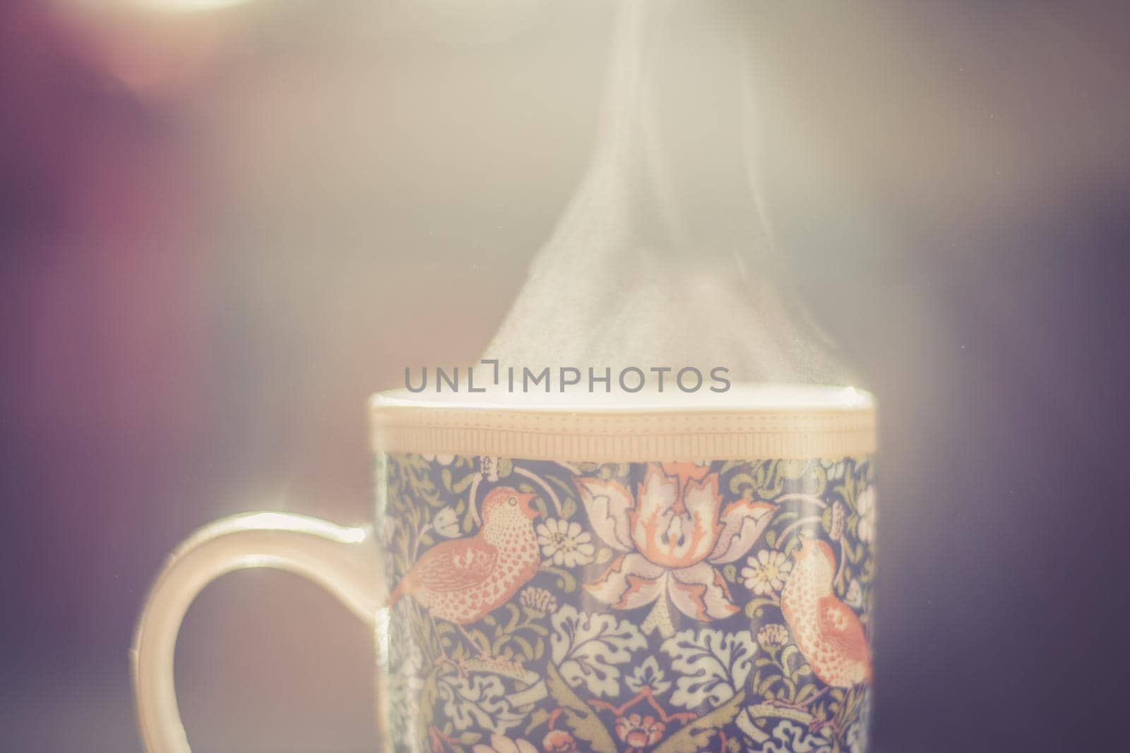 Steaming tea cup and sunlight, warm-up in winter