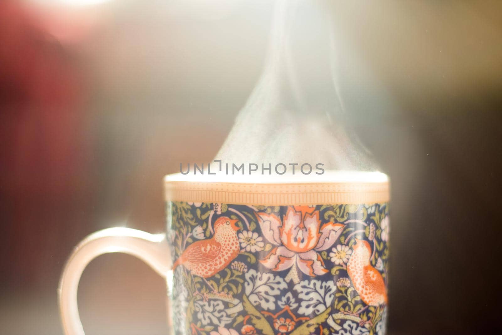 Steaming tea cup and sunlight, warm-up in winter