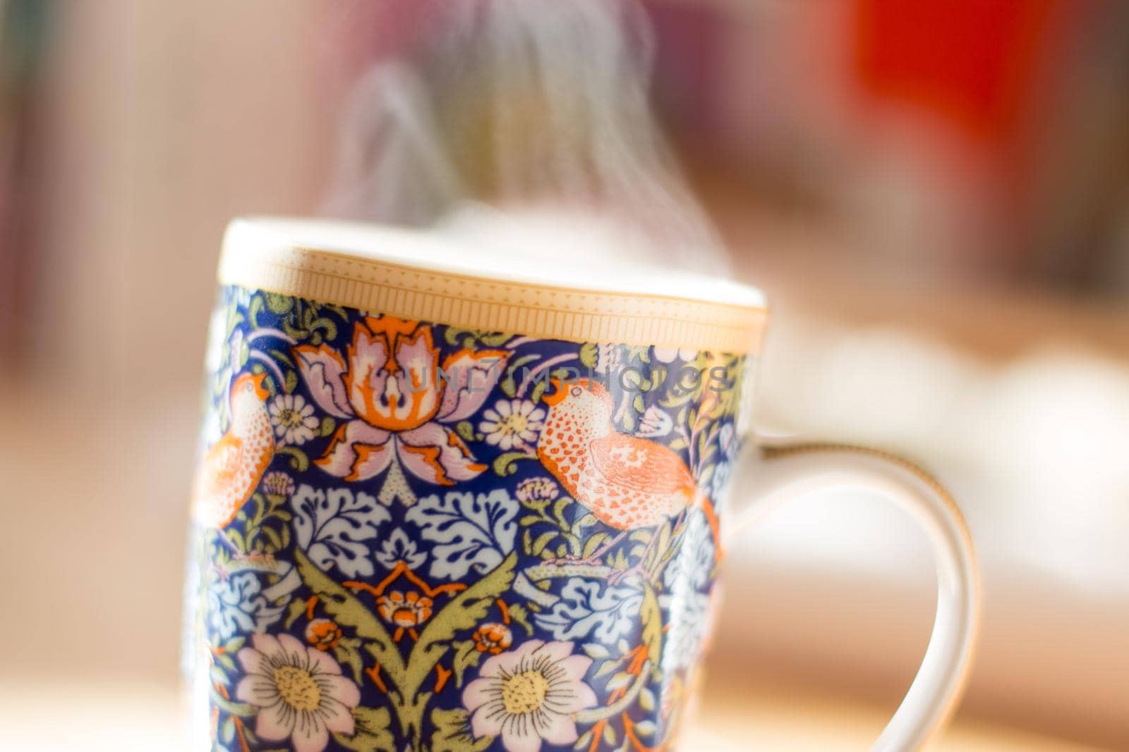 Steaming tea cup and sunlight, warm-up in winter