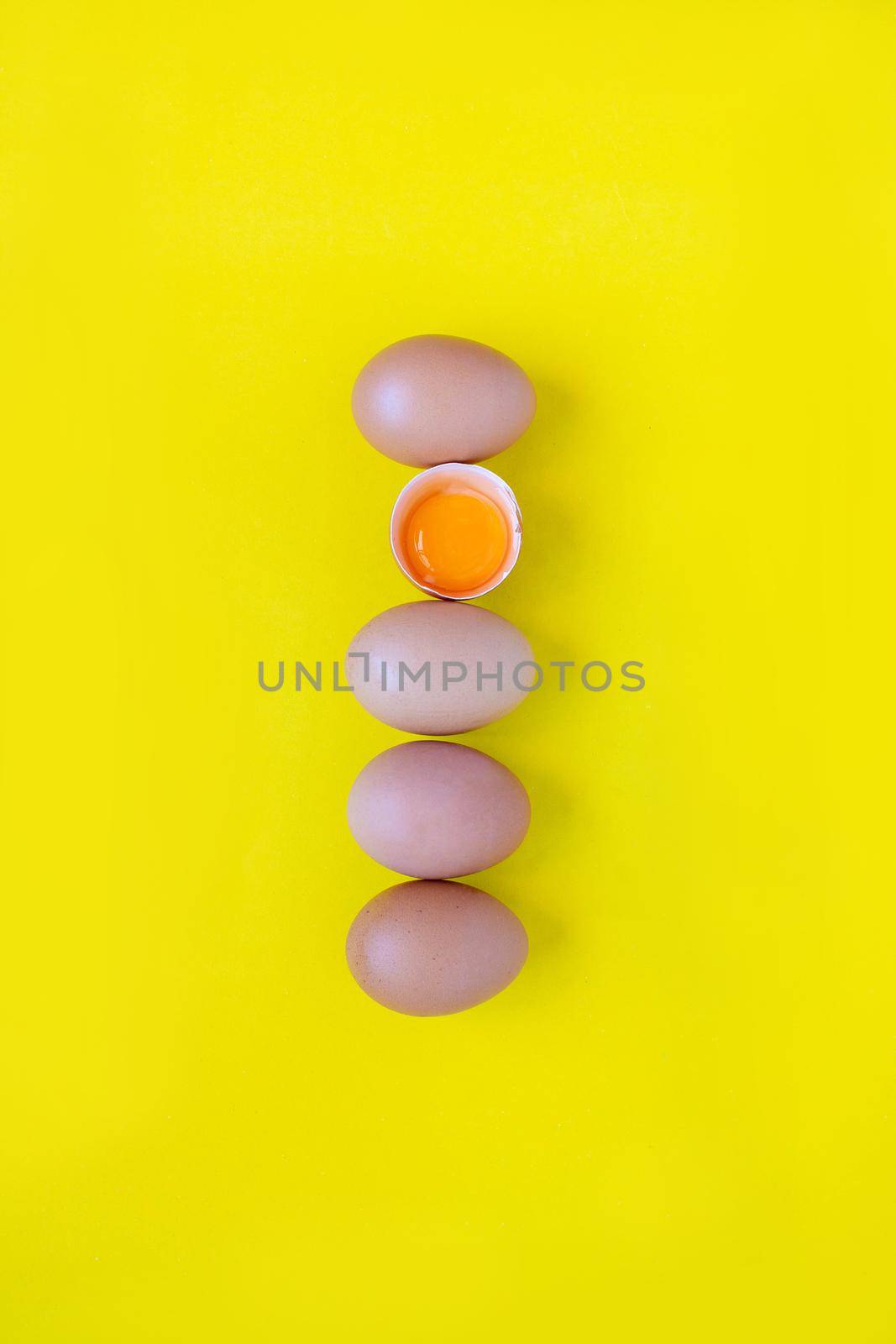 Closeup cracked brown eggs Buy from supermarket Placed side by side on a yellow background