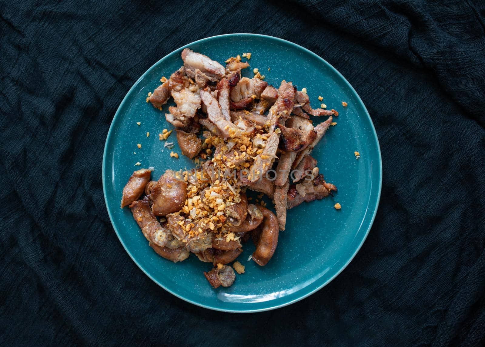 Grilled Pork Neck and Grilled Pork Intestine. Garnish with fried garlic. Local food in Thailand It is a popular food. You can find it at street food stores.