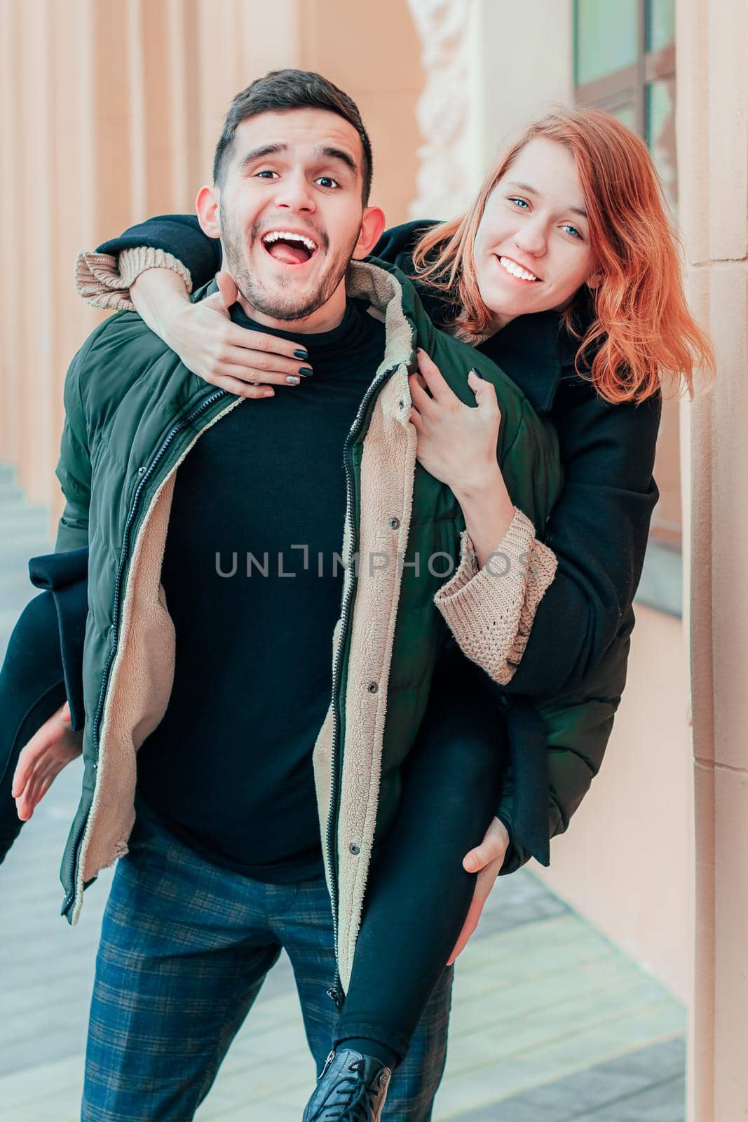 Cheerful Young Couple Hanging on the Street. Two Happy Loving People Having Fun Outdoors - Middle Long Shot