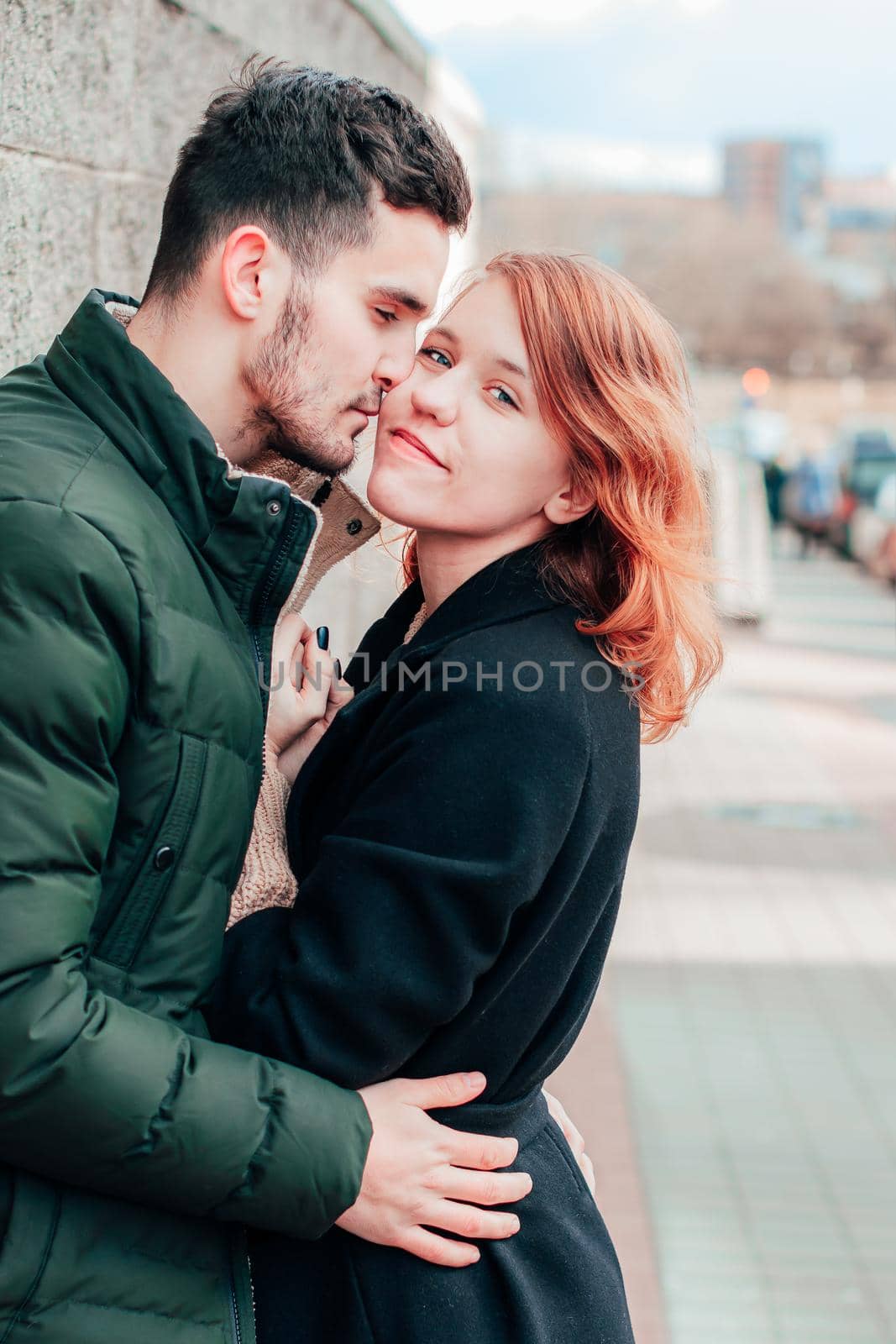 Happy Loving Couple Smiling and Hugging on the Street. Two Happy People Love Story - Medium Shot Portrait