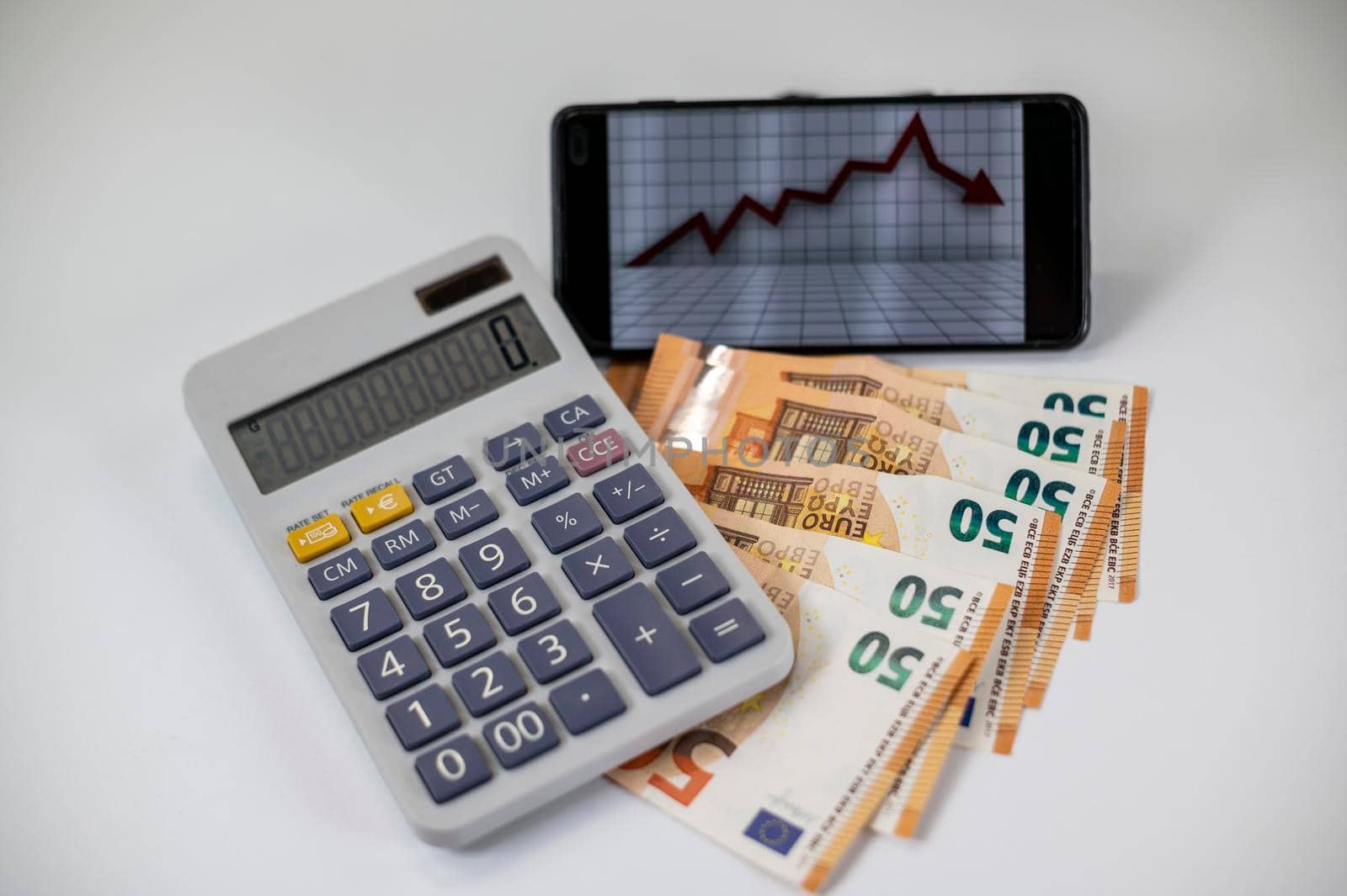 50 euro bills with calculator and graph on white background