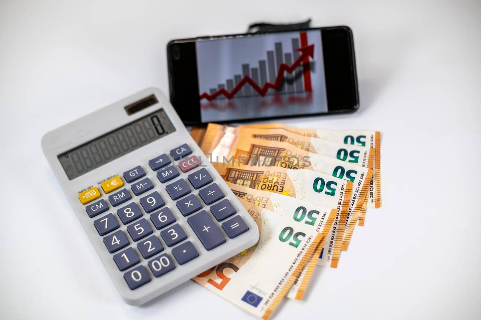 50 euro bills with calculator and graph on white background