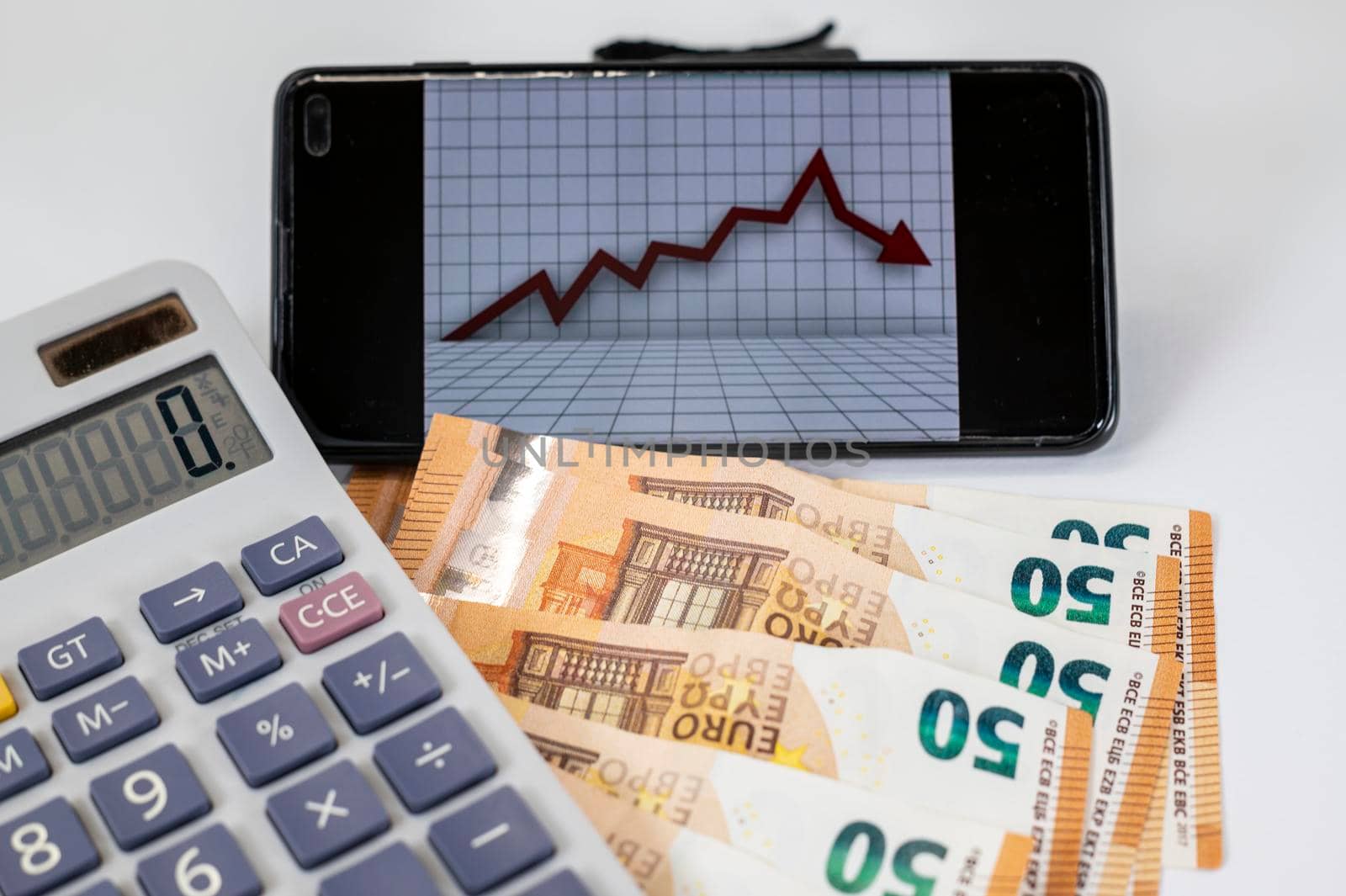 50 euro bills with calculator and graph on white background