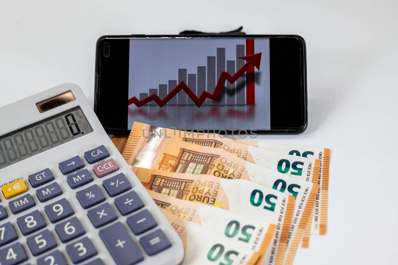 50 euro bills with calculator and graph on white background
