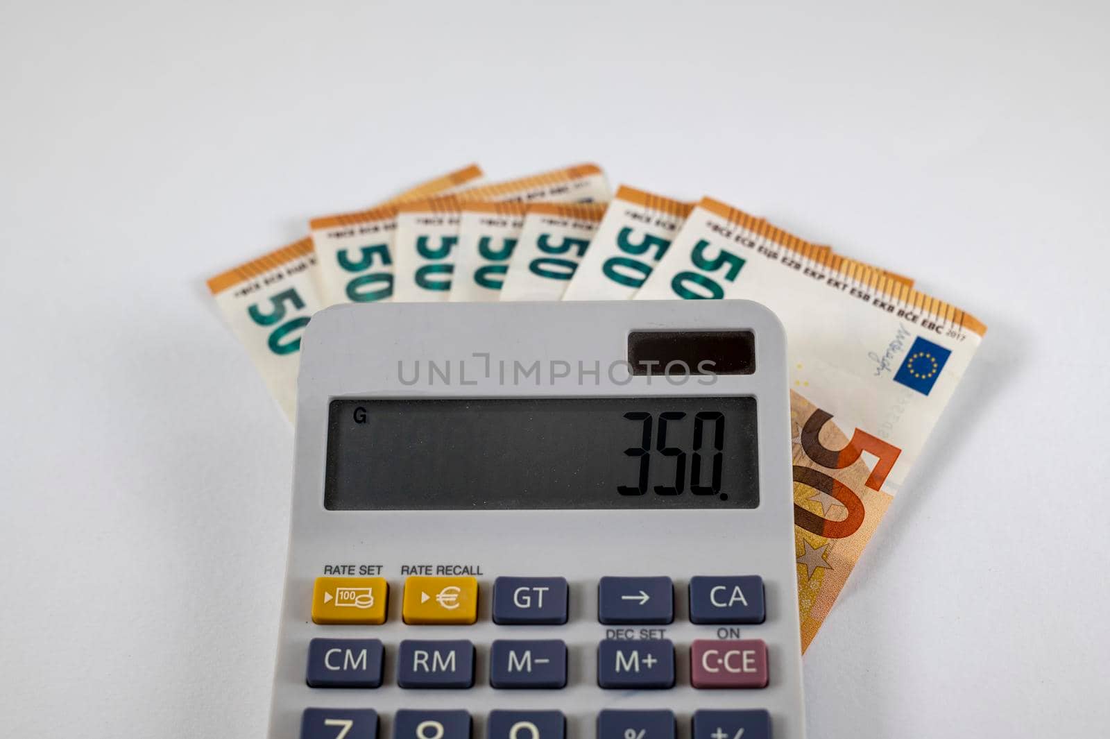 50 euro banknotes with calculator on white background