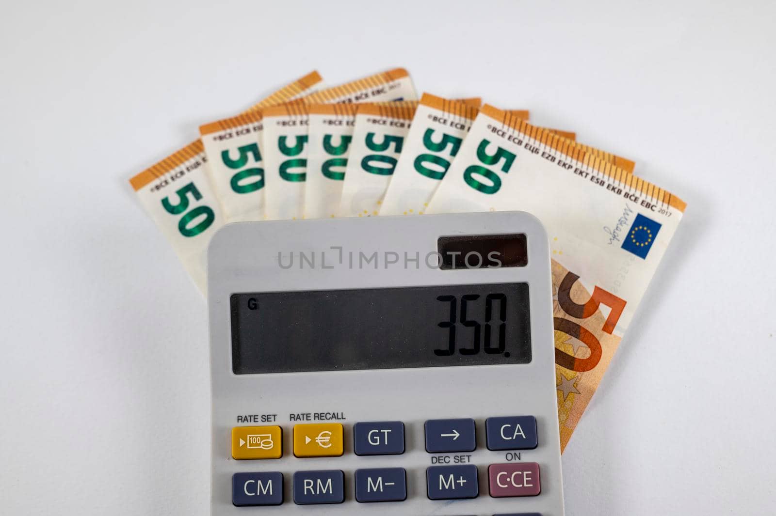 50 euro banknotes with calculator on white background
